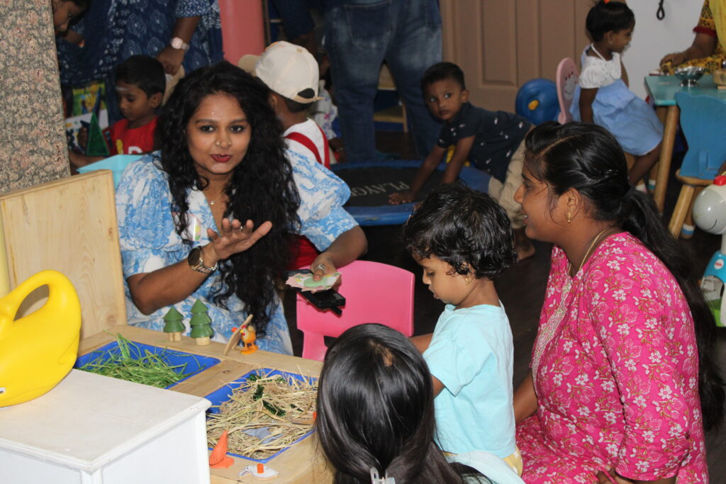 The founder of the playschool engaged in a thoughtful discussion with parents during an event